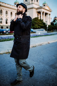 Full length of man standing on street in city