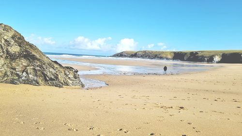 Scenic view of beach against blue sky