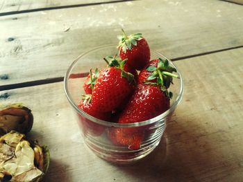 High angle view of strawberries in glass bowl on table