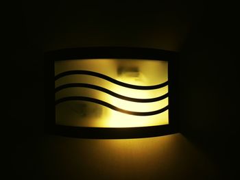 Close-up of illuminated lamp in darkroom