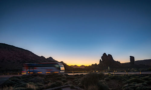 Scenic view of mountains against clear blue sky