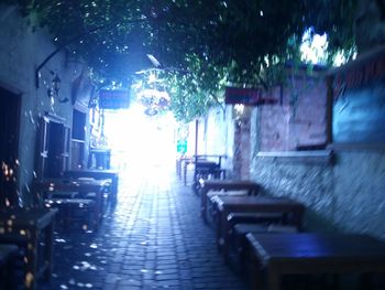 Narrow alley along buildings at night