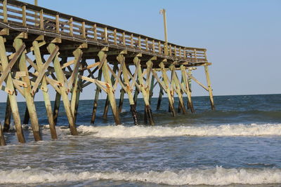 Pier over sea against clear sky