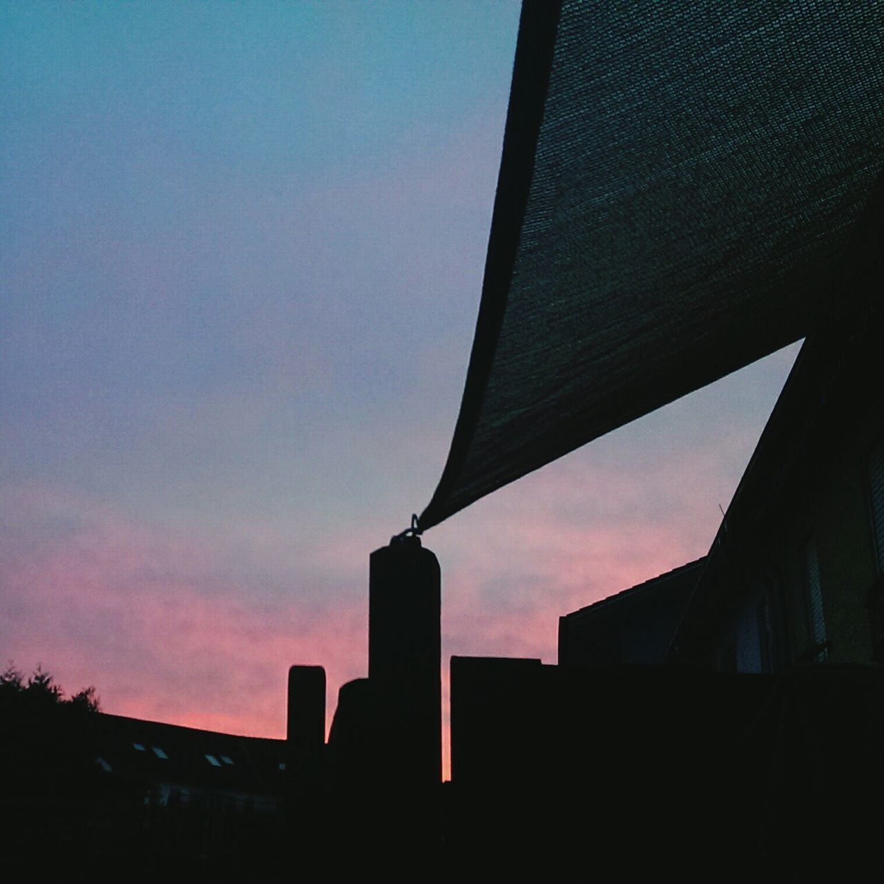 architecture, built structure, building exterior, silhouette, low angle view, sky, sunset, building, city, cloud - sky, dusk, outdoors, no people, cloud, tower, outline, high section, cloudy, skyscraper, sunlight