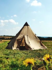 Tent on field against sky