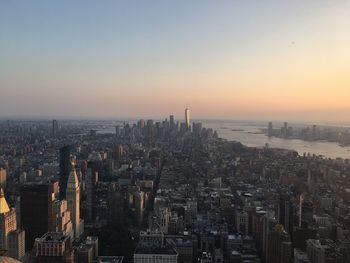 Aerial view of buildings in city during sunset