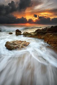 Scenic view of sea against cloudy sky