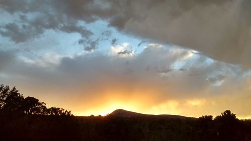 Scenic view of silhouette mountain against sky at sunset