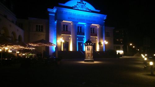 Illuminated building against sky at night