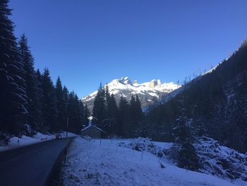 Scenic view of snowcapped mountains against clear sky