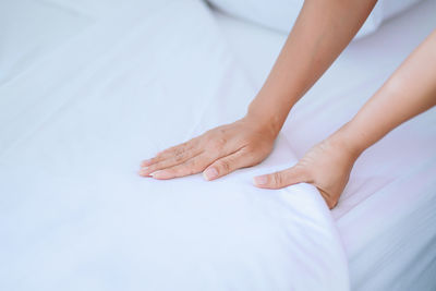 Low section of woman lying on bed