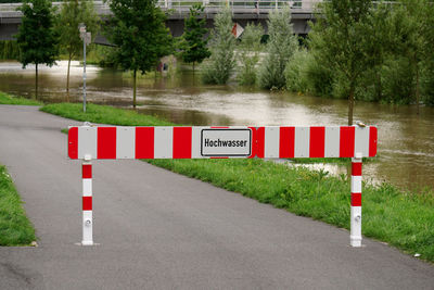 Warning sign on road in flooded area