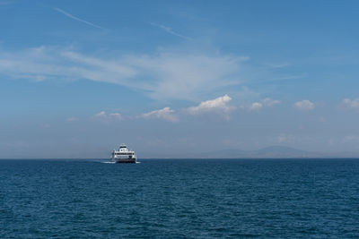 Sailboat sailing on sea against sky