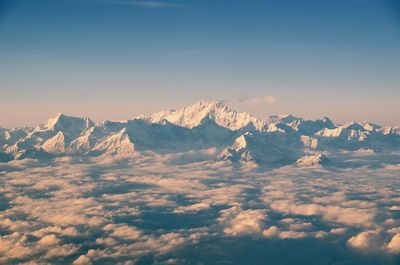 Aerial view of clouds against snowcapped mountains