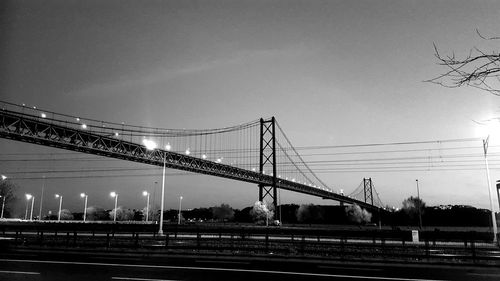 Suspension bridge against sky at night