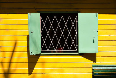 Open window of yellow house