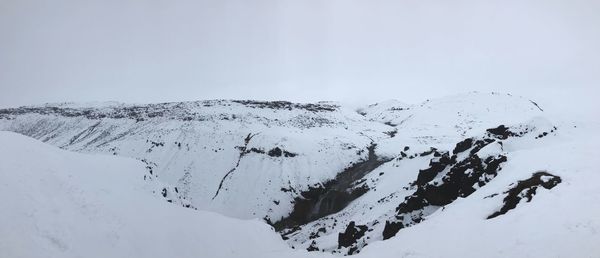 Scenic view of snow covered mountains against sky