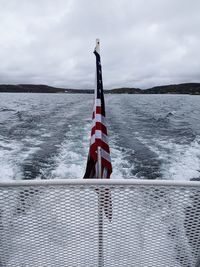 Flag on sea against sky