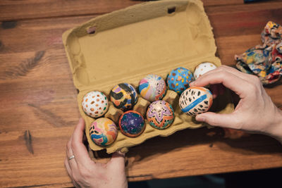 Placing painted easter eggs on an egg carton