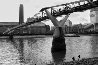Low angle view of london millennium bridge over thames river against sky