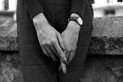 Midsection of woman standing against railing