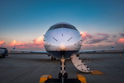 Airplane at runway during sunset
