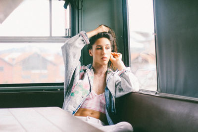 Portrait of woman sitting by window