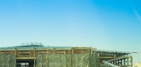 Low angle view of building against clear blue sky