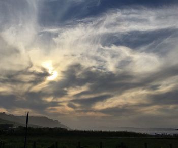 Scenic view of silhouette field against sky during sunset