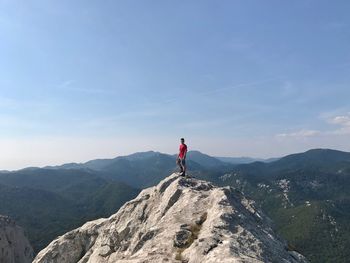 Man standing on mountain against sky