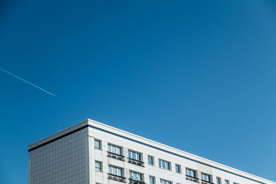 Low angle view of building against clear blue sky