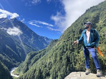 Full length of man standing on mountain against sky