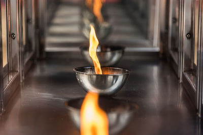 Close-up of lit candles in temple