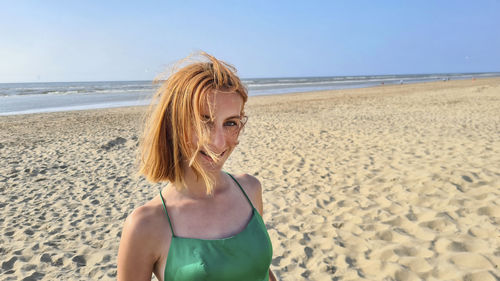 Young woman standing at beach