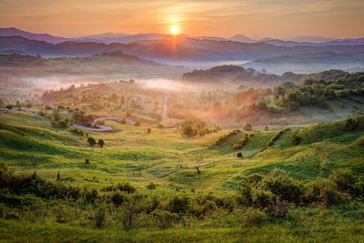 Scenic view of landscape against sky during sunset