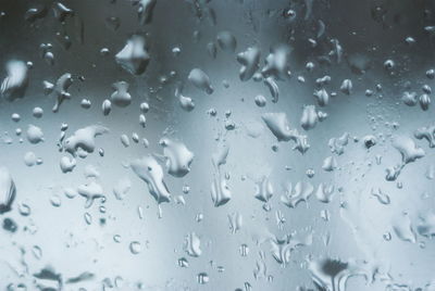 Full frame shot of raindrops on glass window