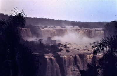 Scenic view of waterfall against sky