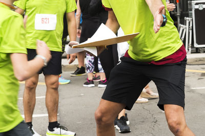 Midsection of people discussing in marathon