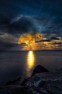 Scenic view of sea against sky at sunset