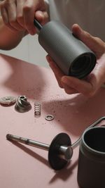 Cropped image of man holding coffee equipment