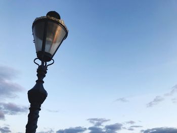 Low angle view of illuminated street light against sky