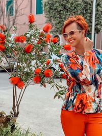 Smiling young woman wearing sunglasses standing outdoors