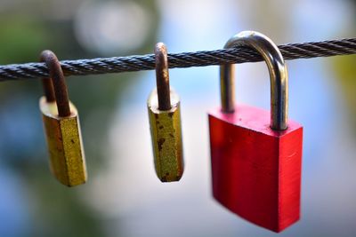 Close-up of padlocks hanging on railing