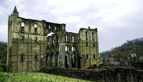 Old ruins of abbey  against cloudy sky