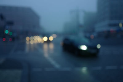Defocused image of cars on road at night