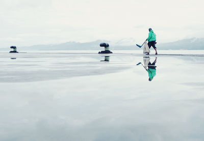 People on sea against sky