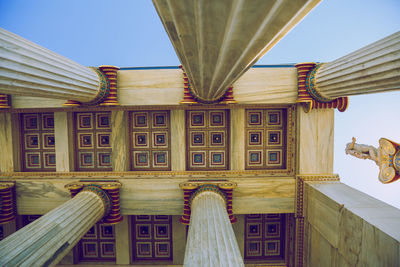 Low angle view of sculptures on building against sky