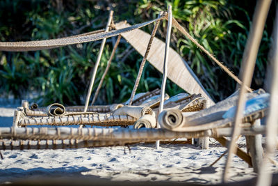 Close-up of boats moored at beach