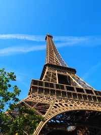 Low angle view of tower against cloudy sky