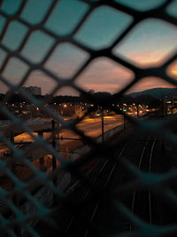 Illuminated cityscape seen through train window